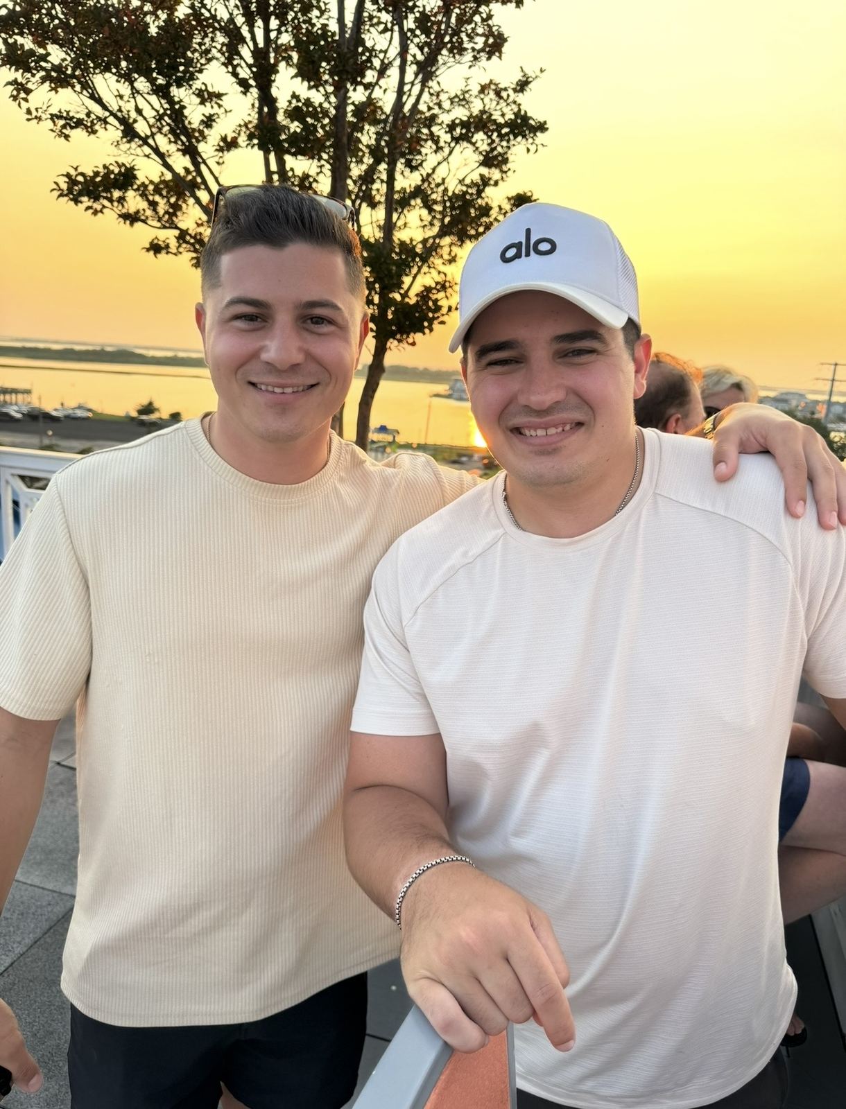 Pete with a friend on a rooftop at sunset